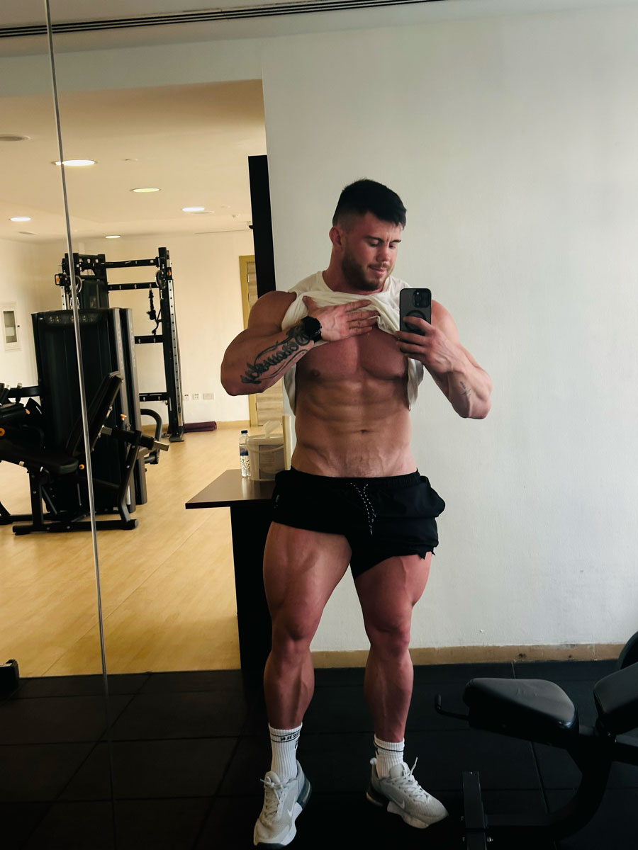 The coach is posing while he is looking at the mirror.